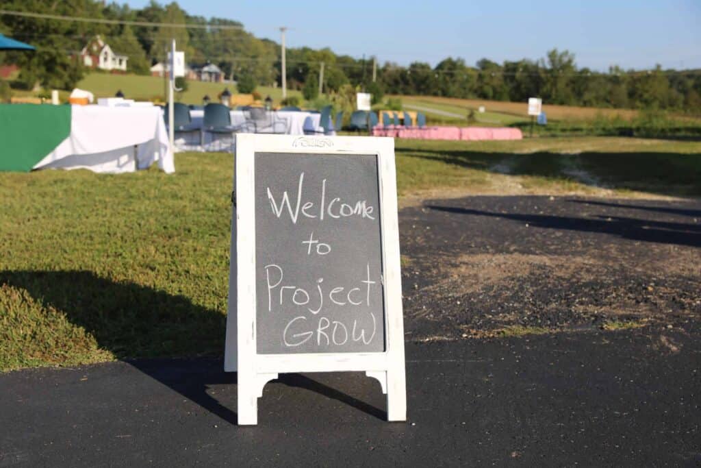 A chalk sign reading Welcome Back to Project Grow