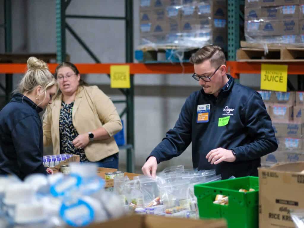 Kroger Volunteers packing boxes