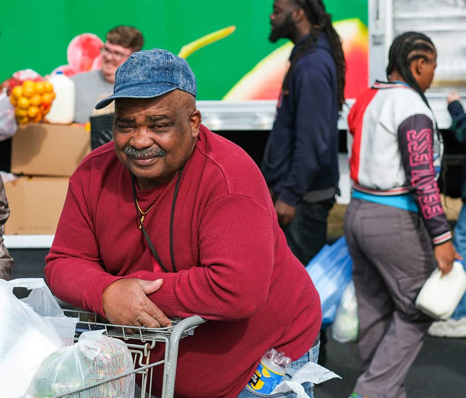 A man with a cart filled with food