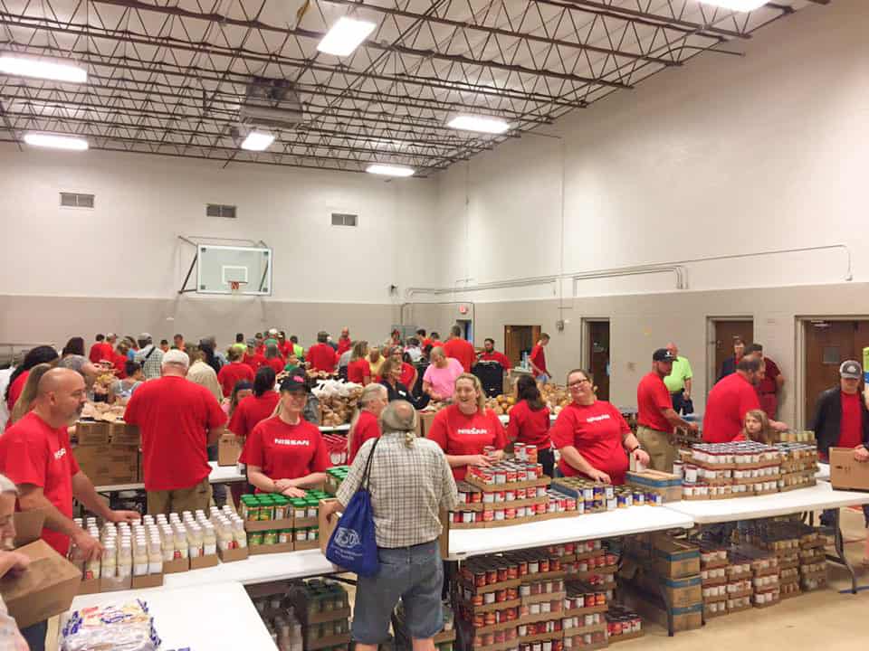 Dozens of Nissan employees volunteering at a Second Harvest Mobile Pantry packing food to be distributed to people facing hunger at Winchester First Baptist Church